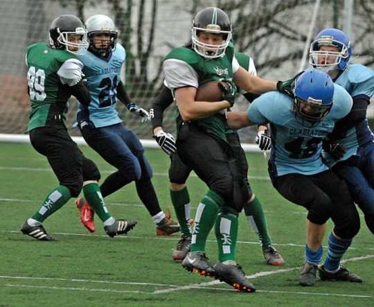 Club President Ollie Tribe palms off a defender.