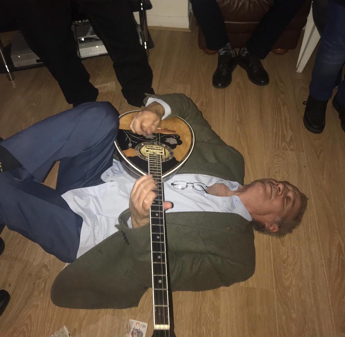 Image may contain: Flooring, Floor, Shoe, Clothing, Apparel, Footwear, Hardwood, Guitar, Musical Instrument, Leisure Activities, Human, Person, Wood