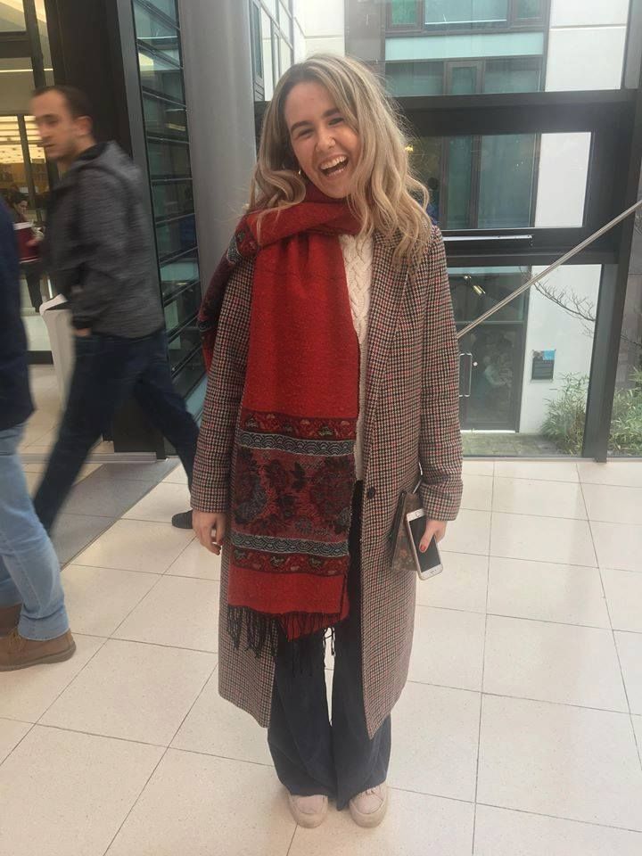 Image may contain: Long Sleeve, Overcoat, Sweater, Sleeve, Coat, Footwear, Shoe, Human, Person, Clothing, Apparel