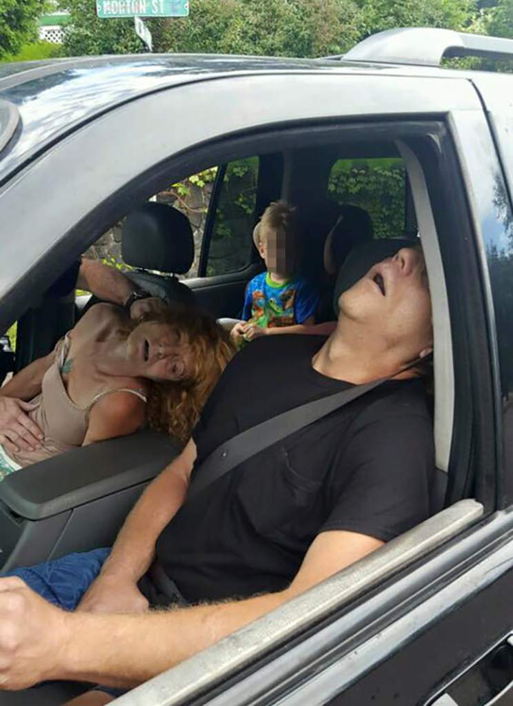 PA police released these harrowing images of two adults overdosing on heroin in a car with their child in the backseat