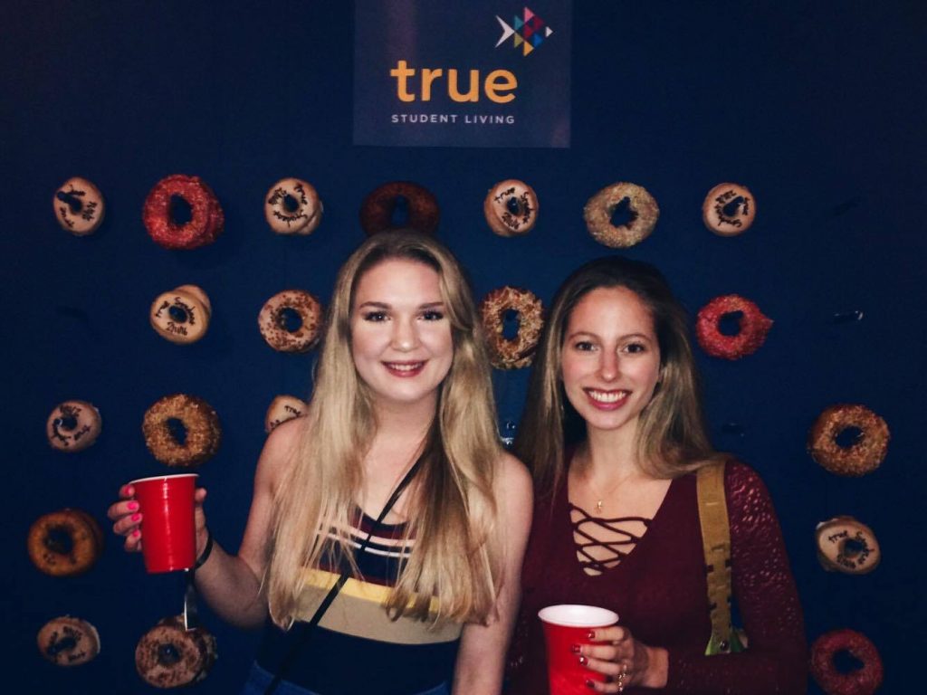 The Tab writers featuring giant donut wall