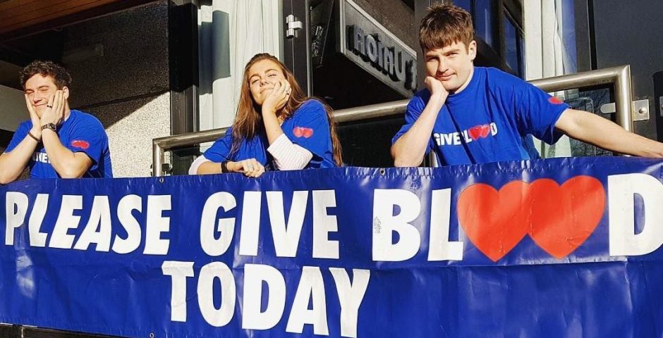 Image may contain: Text, Banner, Team, Person, People, Human