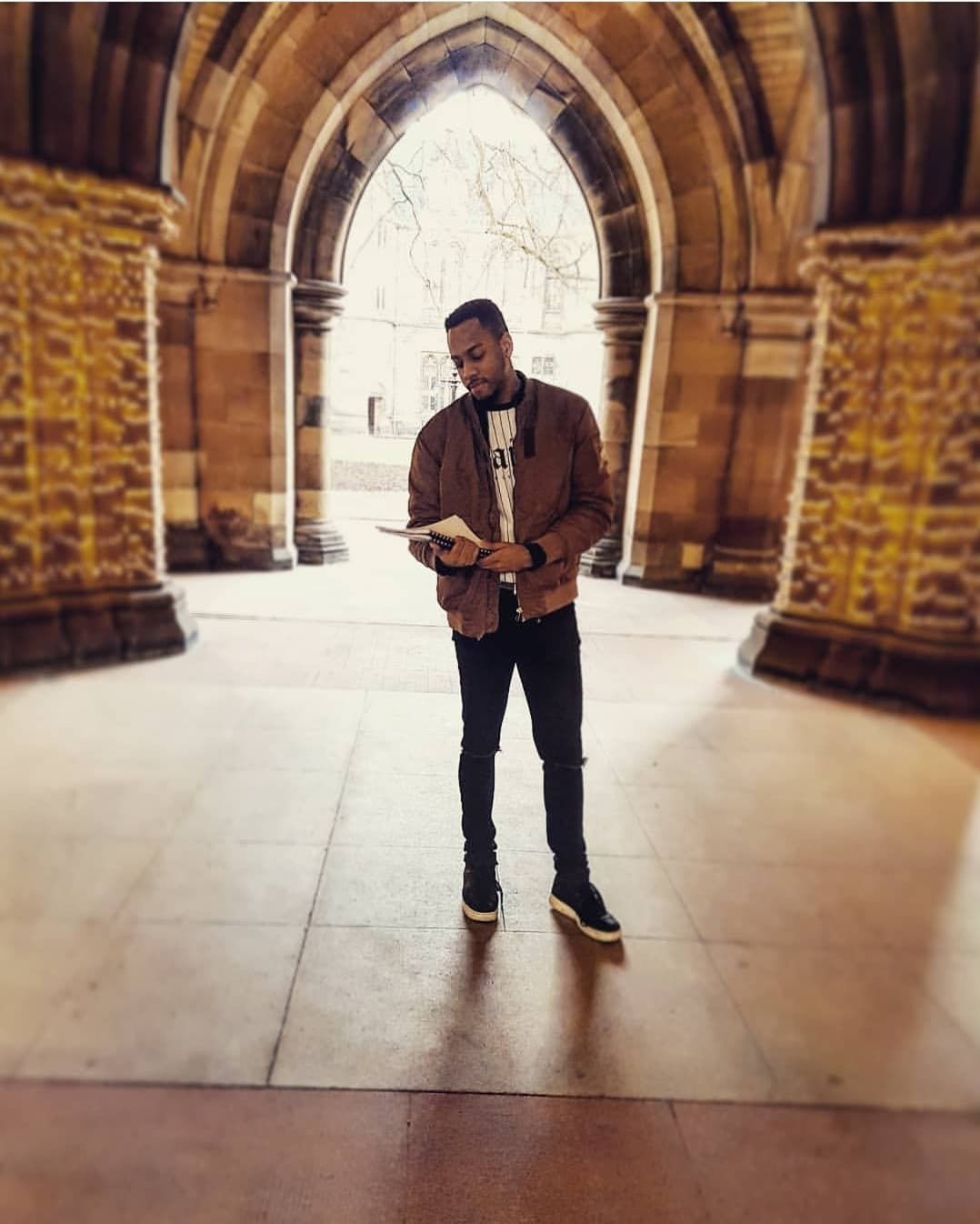 Image may contain: Pants, Building, Architecture, Flagstone, Crypt, Corridor, Floor, Flooring, Person, Human, Clothing, Apparel, Shoe, Footwear