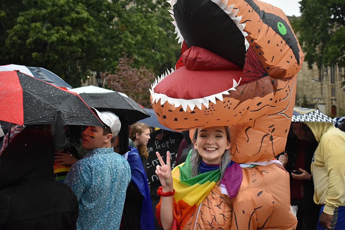 Megan Hiser poses in a dino-suit featuring a nice rainbow addition.