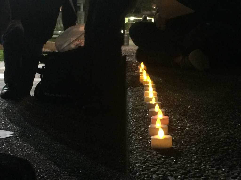 Tea lights are lit at the Bell Tower to commemorate transgender people who have lost their lives.