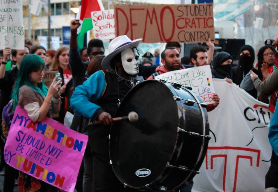 Three masked drummers signaled the arrival of Temple's group of protesters.