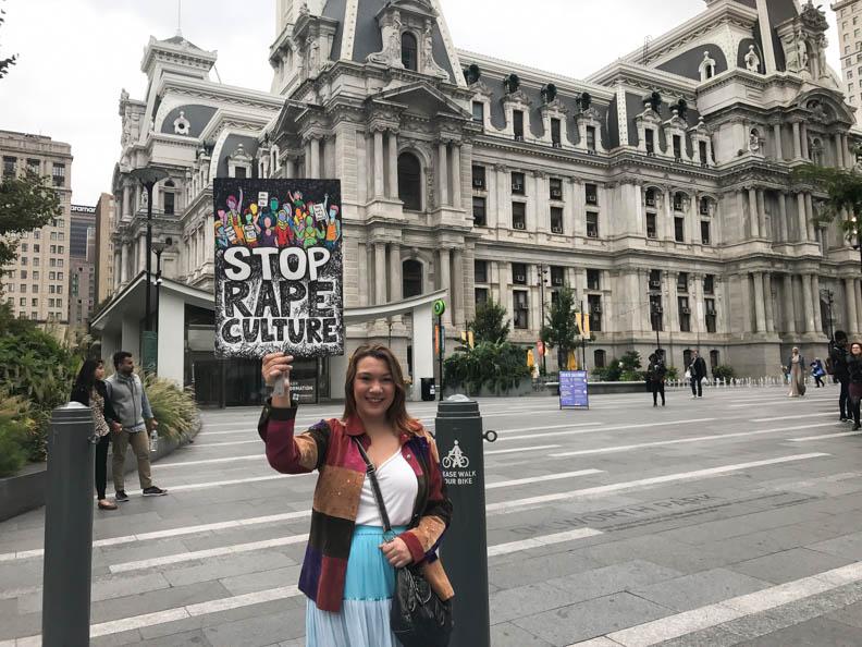 Temple sophomore, Nichole Mottershead, holds a sign she made.