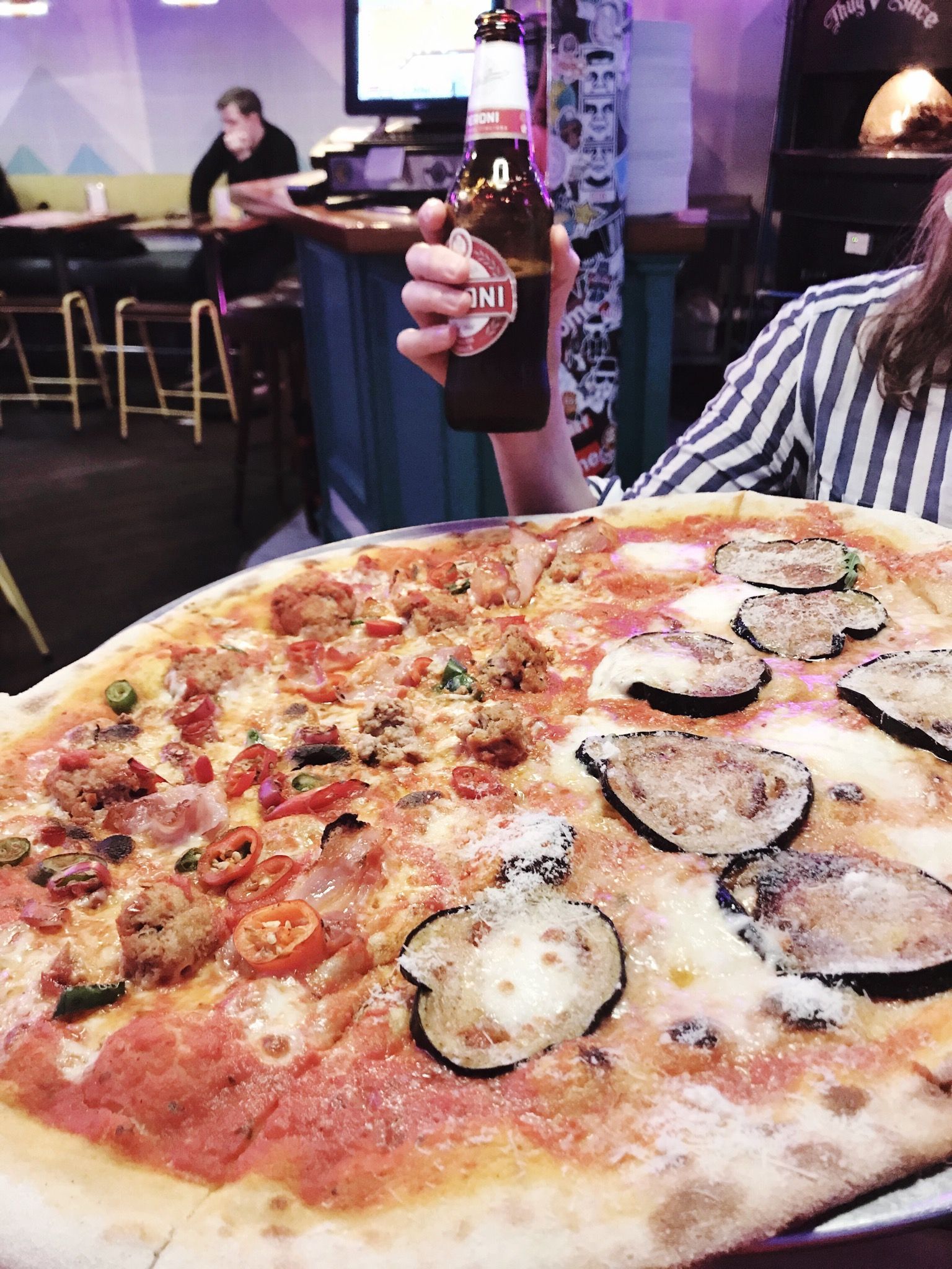 Image may contain: Chair, Furniture, Plant, Meal, Beverage, Alcohol, Drink, Beer, Person, Human, Food, Pizza