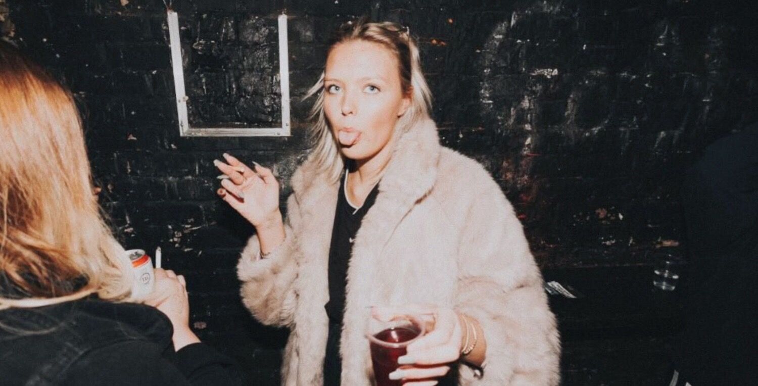 Image may contain: Drink, Beverage, Jacket, Overcoat, Coat, Human, Person, Apparel, Clothing