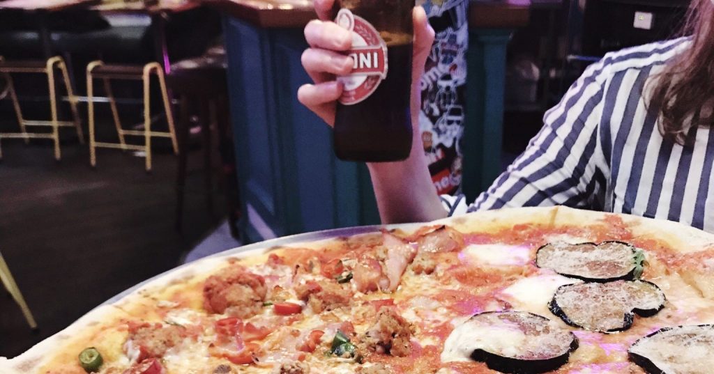 Image may contain: Meal, Human, Person, Food, Pizza