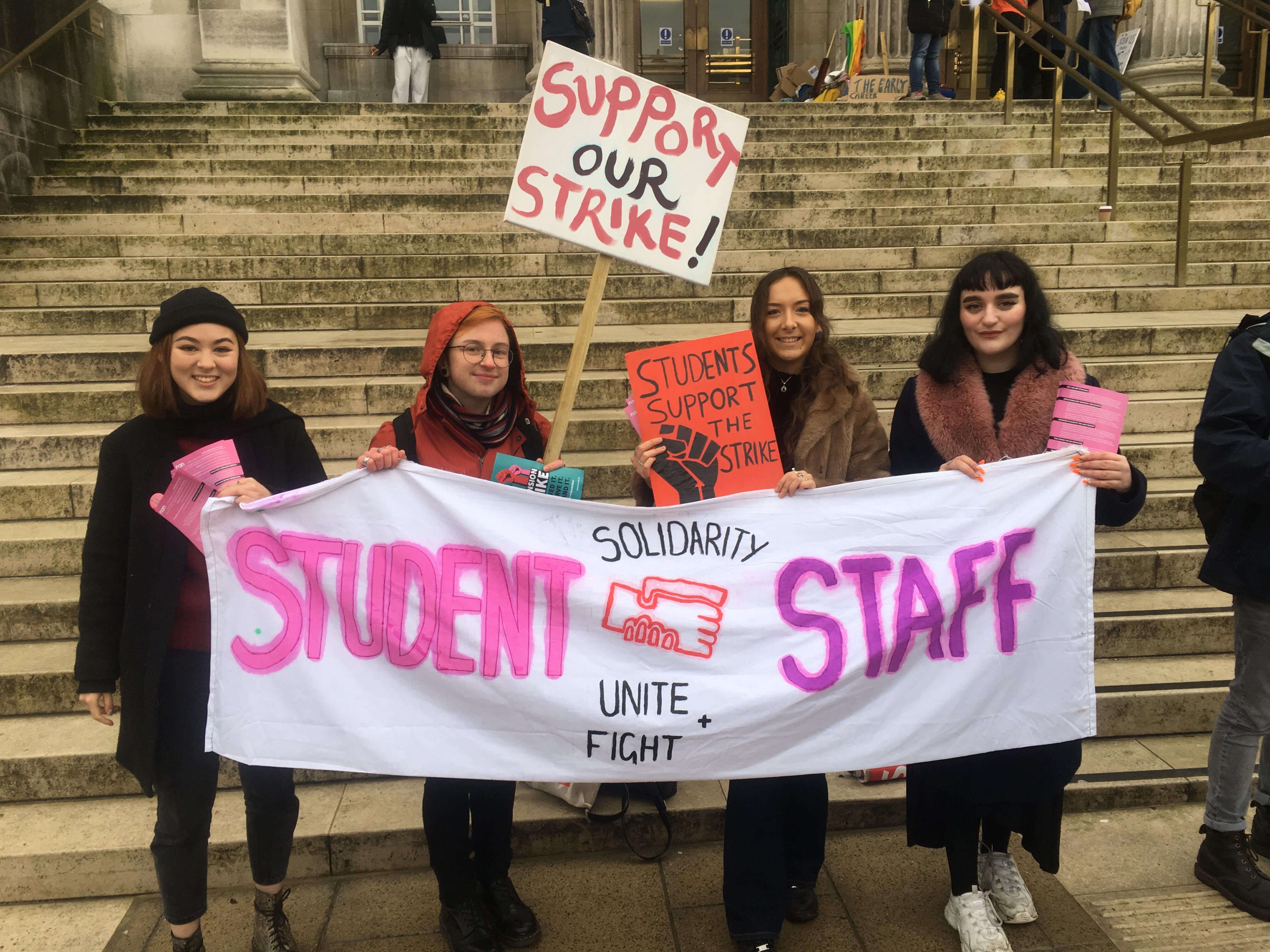 Image may contain: Crowd, Shoe, Footwear, Apparel, Clothing, Person, Human, Text, Banner