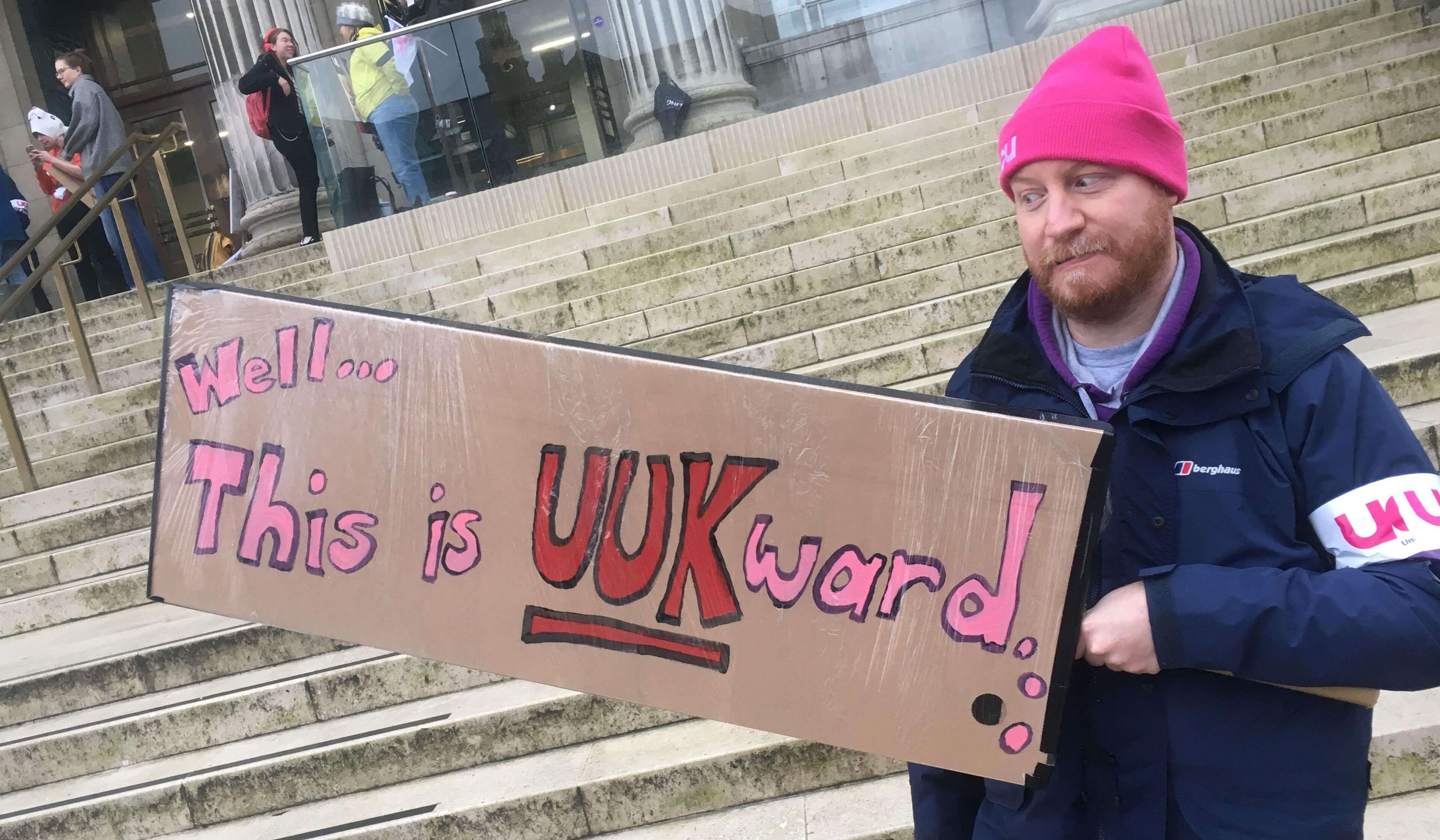 Image may contain: Hat, Face, Clothing, Apparel, Word, Banner, Text, Person, Human