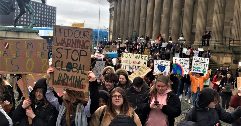 Image may contain: People, Text, Protest, Parade, Crowd, Person, Human