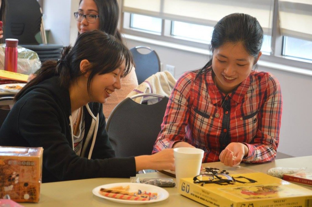 Playing Five in a Row, a traditional Eastern Asian board game, with my friend at a VUCA GBM.