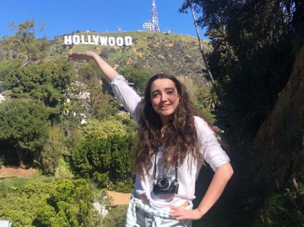 Image may contain: Tourist, Girl, Mountain, Land, Grass, Photography, Photo, Portrait, Rock, Nature, Woman, Pants, Smile, Bush, Outdoors, Tree, Vacation, Female, Shorts, Face, Human, Person, Clothing, Apparel, Vegetation, Plant