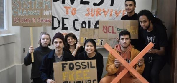 Image may contain: People, Banner, Crowd, Parade, Protest, Word, Text, Human, Person