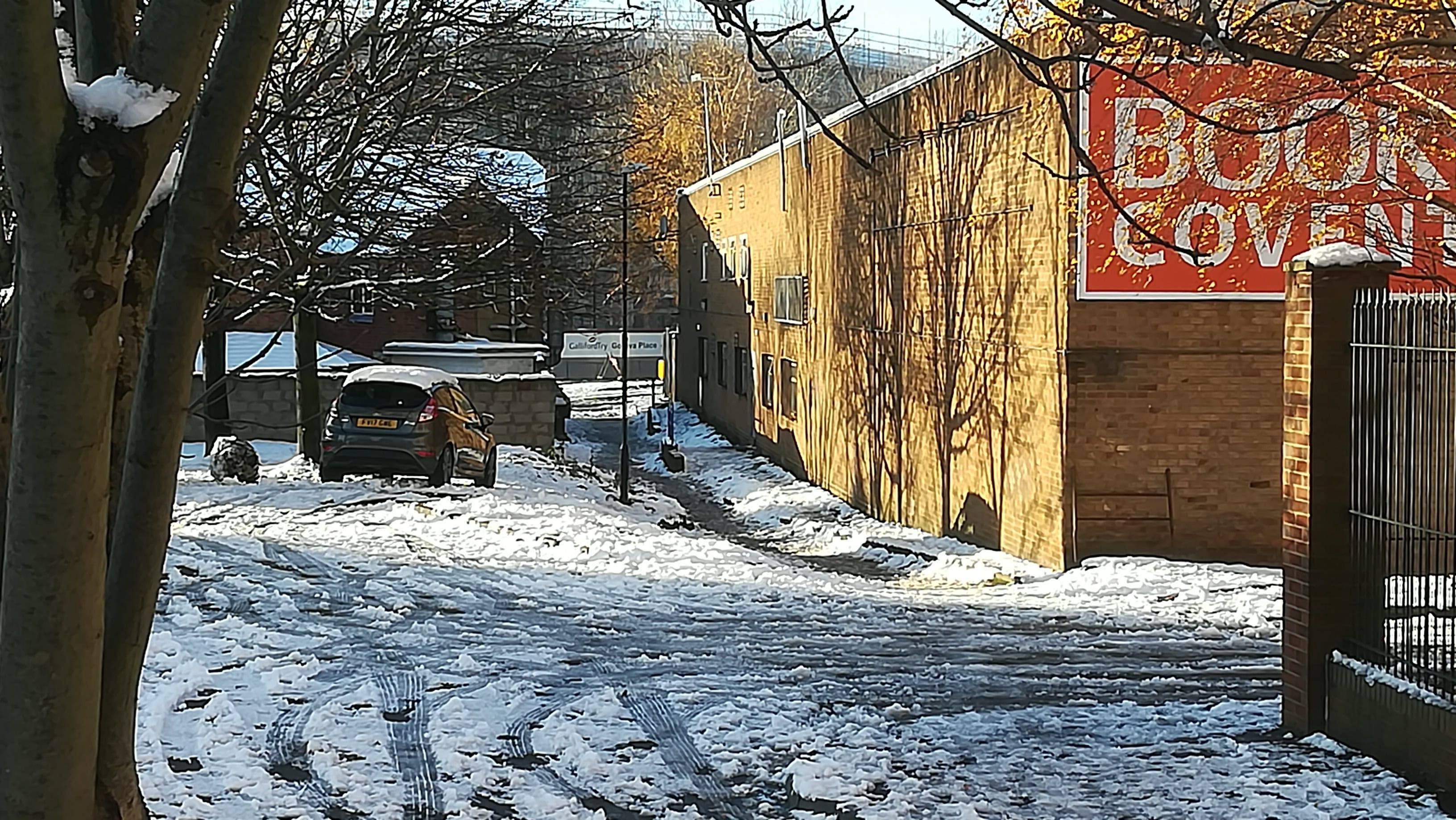 Image may contain: Urban, Town, Street, Road, City, Building, Alleyway, Alley, Snow, Outdoors, Tree, Plant, Flora, Birch