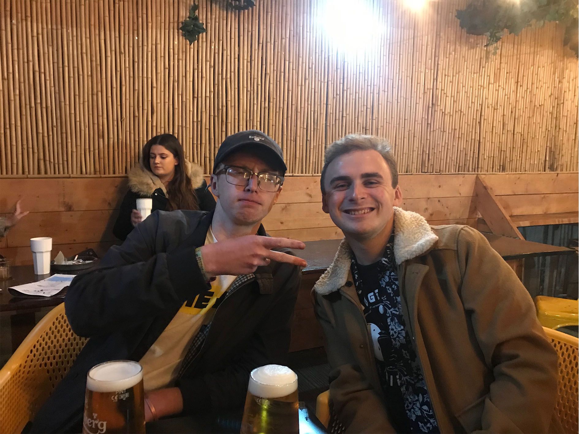 Image may contain: Bar Counter, Scarf, Apparel, Clothing, Pub, Accessories, Accessory, Glasses, Sitting, Beer Glass, Glass, Human, Person, Drink, Beer, Alcohol, Beverage