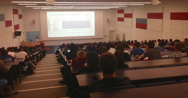 Image may contain: Speech, Toy, Teddy Bear, Conference Room, Classroom, Audience, Furniture, Couch, Human, Person, People