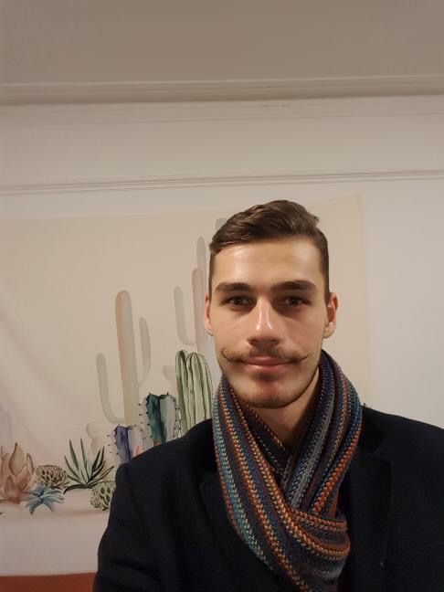 Image may contain: Coat, Photography, Photo, Portrait, Scarf, Man, Face, Human, Person, Apparel, Clothing