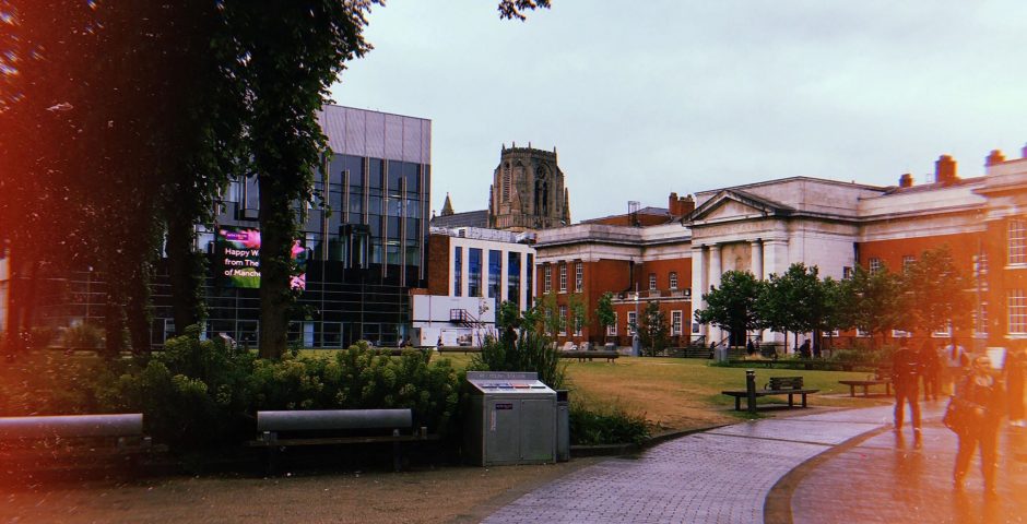 Image may contain: Walkway, Grass, Downtown, Tree, Plant, Flagstone, City, Building, Town, Urban, Path, Person, Human, Campus, Bench, Furniture