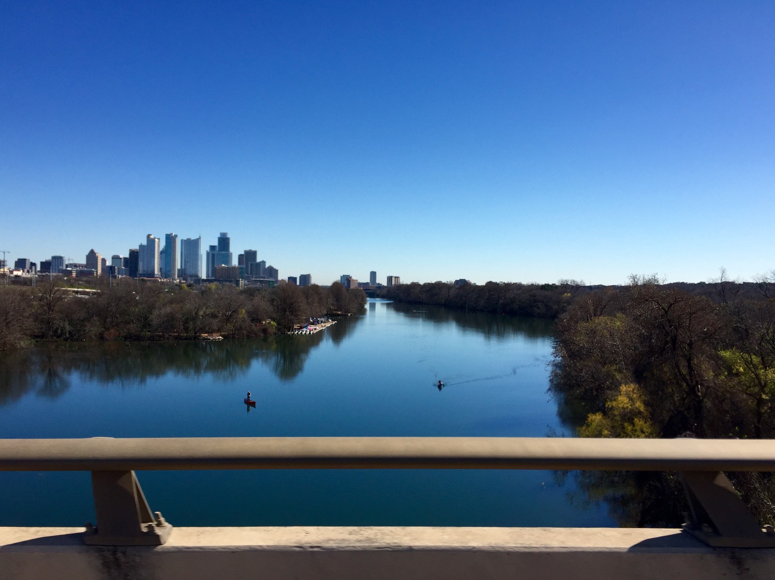 Highway view of Lady Bird Lake during the day.