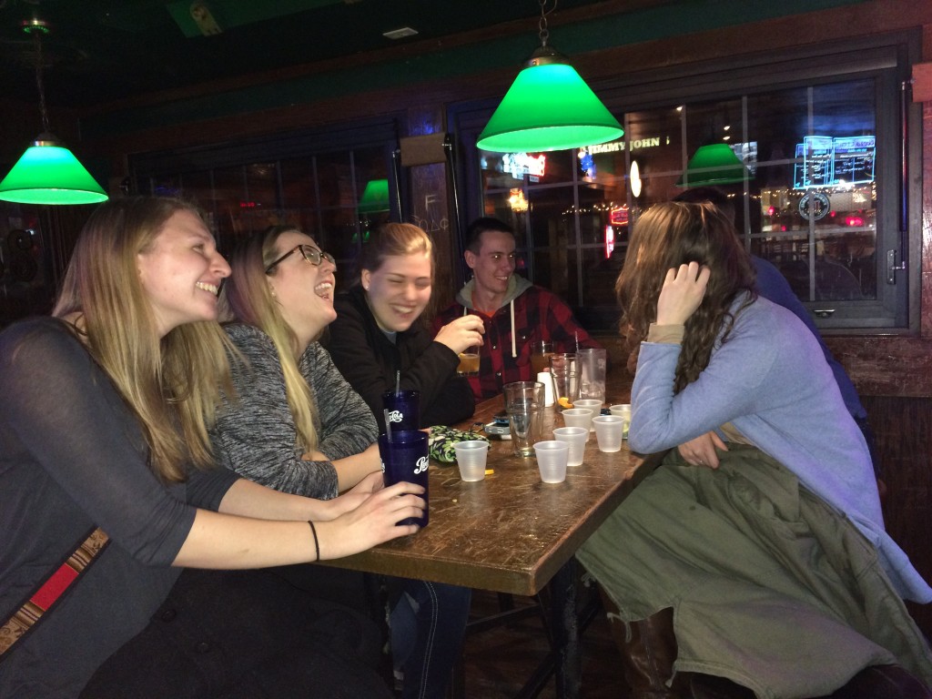 A group of students laugh over drinks at Murphy's