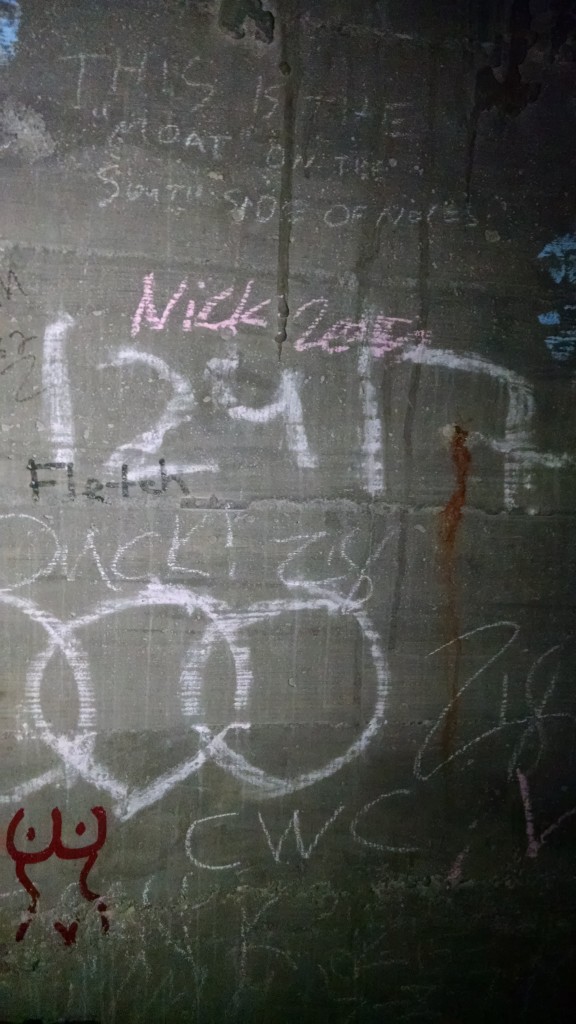The graffitied wall within the steam tunnels