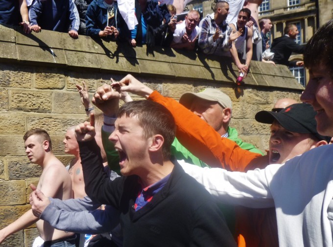 ... and clash with organisers (who try and keep them away from fighting with the police.)
