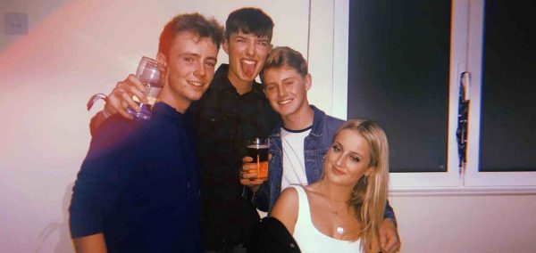 Image may contain: Smile, Portrait, Face, Party, Drink, Beverage, Alcohol, Person, People, Human