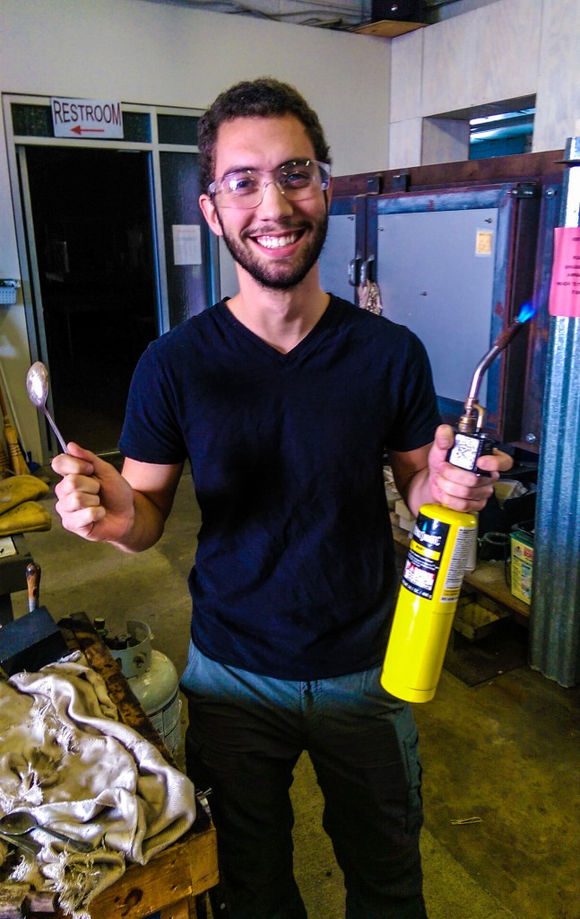 IU student participant John holds sports safety goggles, a spoon, and a blow torch - would you be able to guess what he's doing?