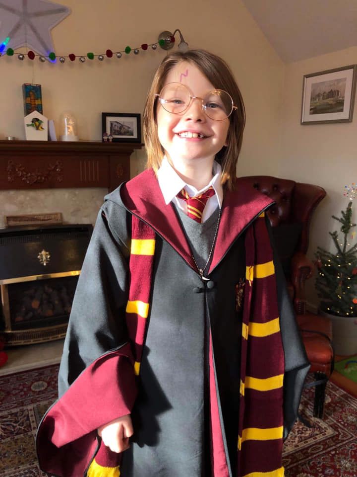 Image may contain: Fashion, Indoors, Portrait, Photo, Photography, Jar, Pottery, Vase, Potted Plant, Plant, Glasses, Girl, Costume, Female, Tie, Accessories, Accessory, Smile, Face, Human, Person, Apparel, Clothing