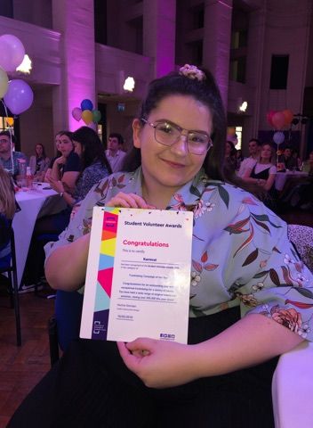 Image may contain: Text, Photo, Portrait, Photography, Crowd, Lighting, Accessories, Glasses, Accessory, People, Female, Clothing, Apparel, Purple, Paper, Party, Face, Chair, Furniture, Person, Human