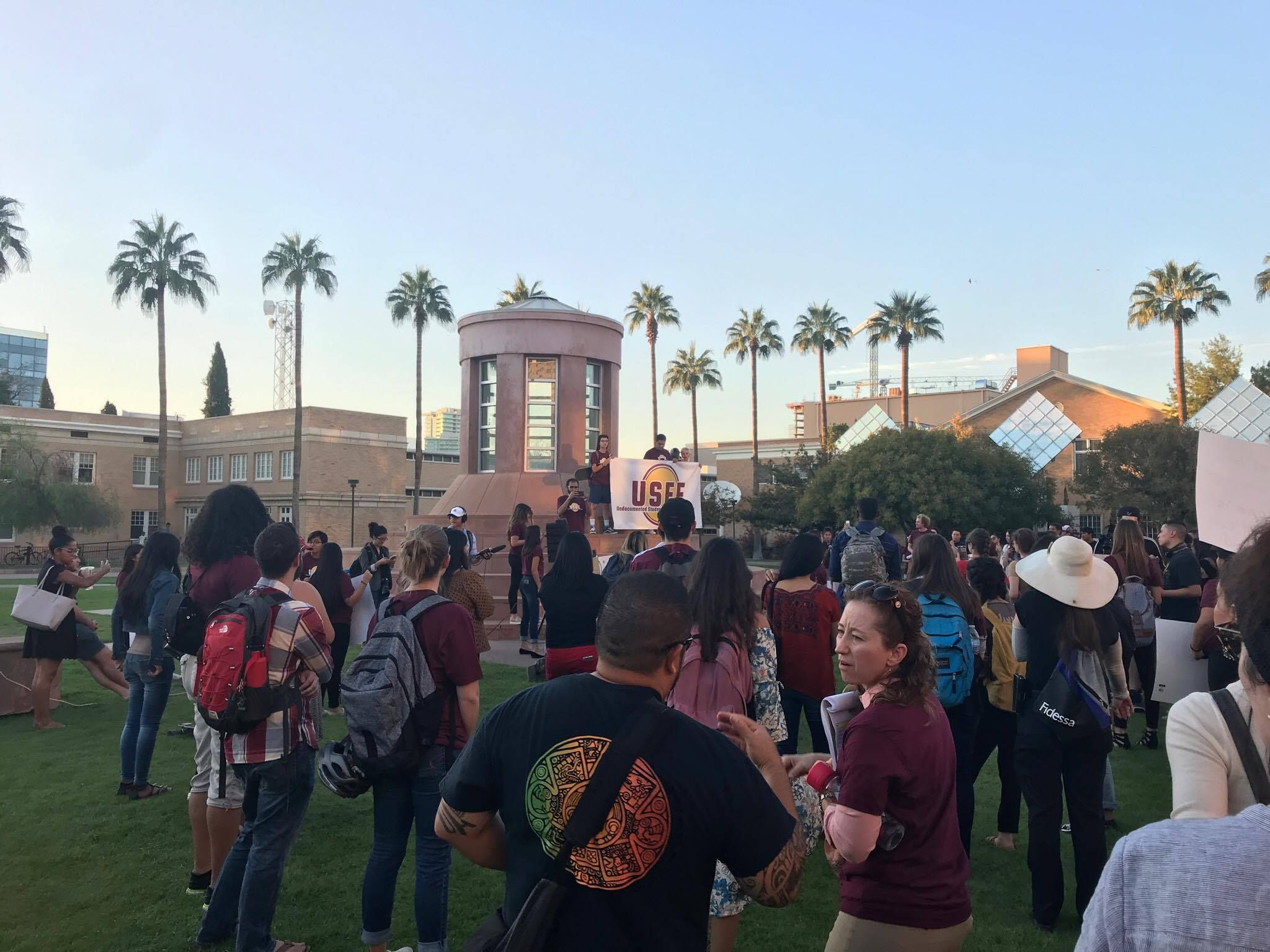 Image may contain: Crowd, Tree, Plant, Palm Tree, Person, People, Human