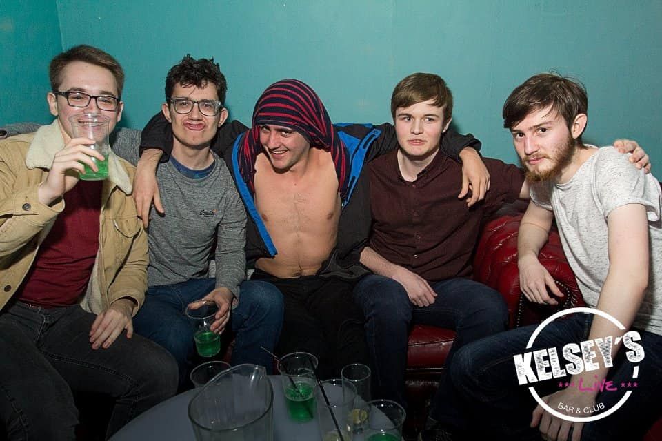 Image may contain: Party, Drink, Beverage, Alcohol, Furniture, Couch, Person, People, Human