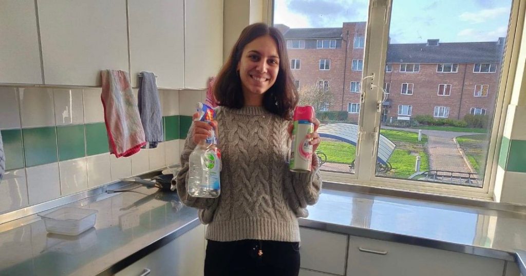 Image may contain: Sweater, Female, Beverage, Drink, Bottle, Home Decor, Apparel, Clothing, Human, Person