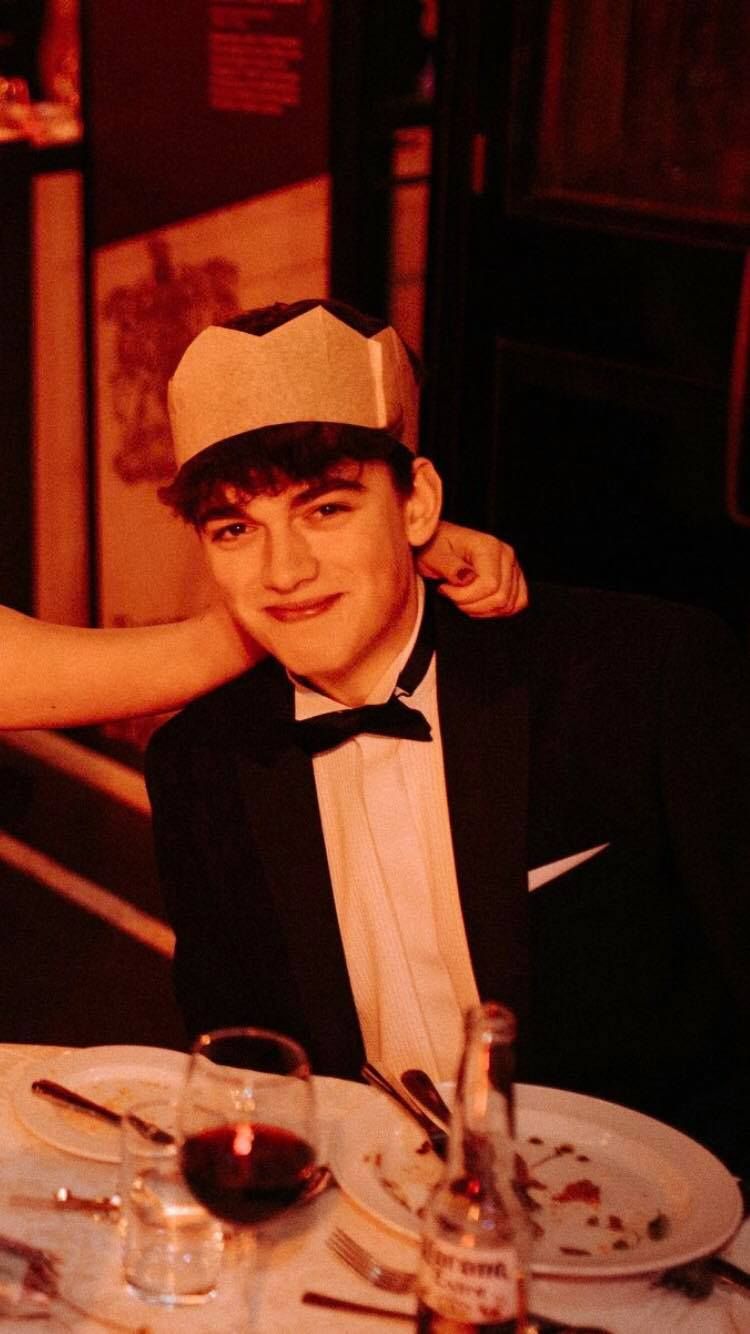 Image may contain: Magician, Tuxedo, Dining Table, Table, Furniture, Hat, Suit, Overcoat, Coat, Performer, Accessories, Accessory, Tie, Apparel, Clothing, Human, Person