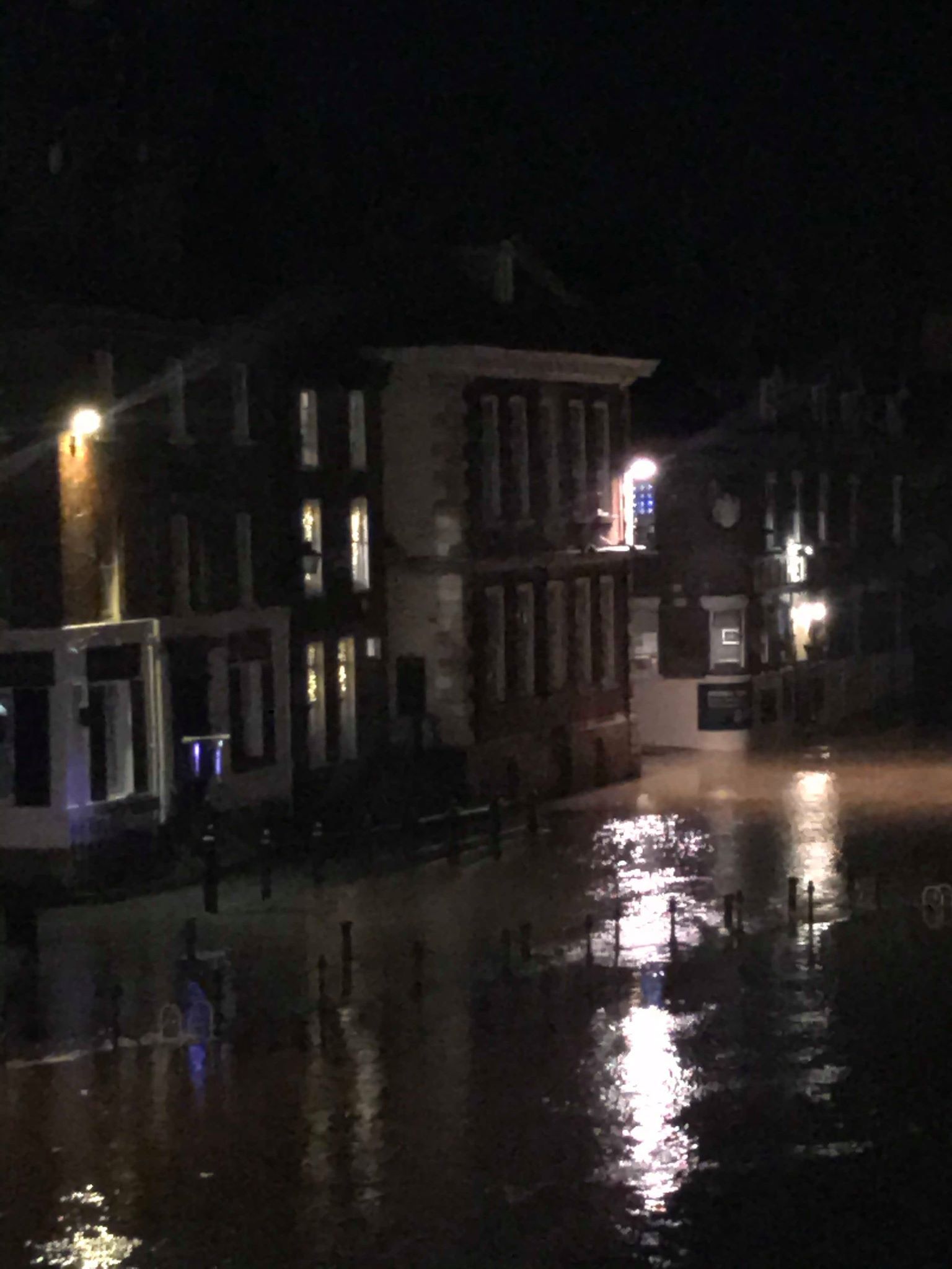 Image may contain: City, Town, Building, Metropolis, Urban, Flood, Road, Nature, Flare, Light, Asphalt, Tarmac, Lighting, Human, Person