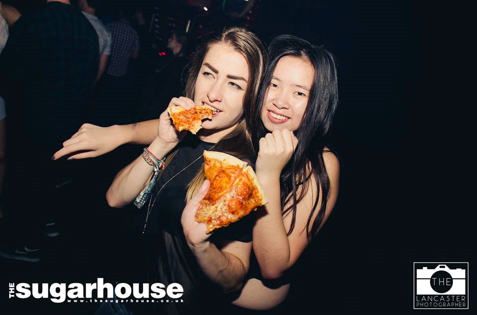What kind of person holds their pizza like that? The kind that would eat pizza in a fucking nightclub.