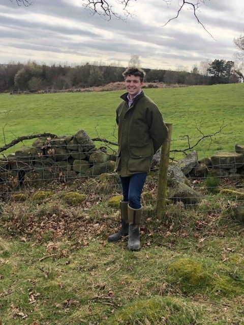 Image may contain: Coat, Boot, Pants, Pasture, Farm, Rural, Countryside, Footwear, Grassland, Field, Outdoors, Person, Human, Nature, Clothing, Apparel