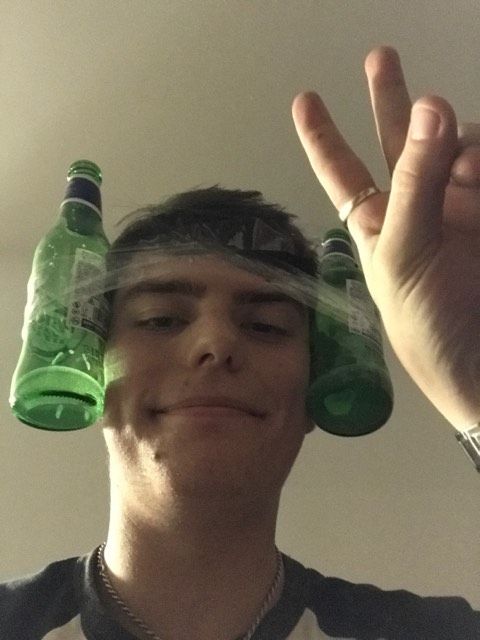 Image may contain: Pop Bottle, Beer Bottle, Finger, Head, Alcohol, Beer, Beverage, Drink, Bottle, Person, Human