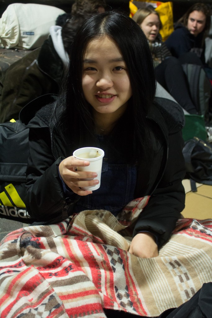 Xin Wen, 18, is a foreign student from China. She warmed herself up with a cup of coffee as the long night began.