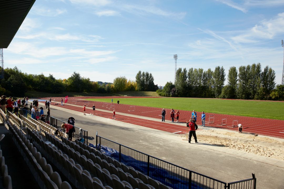 Image may contain: Building, Field, Running Track, Sport, Sports, Person, Human