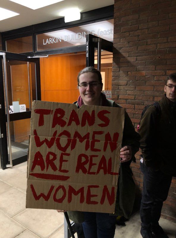 Image may contain: Door, Glasses, Accessories, Accessory, Banner, Text, Person, Human