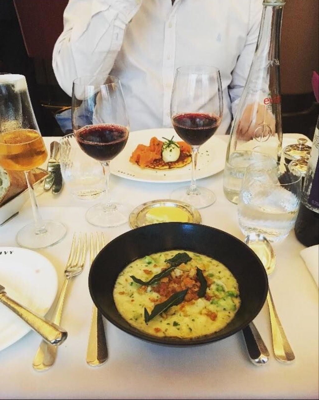 Image may contain: Supper, Dinner, Beer, Human, Person, Wine Glass, Dining Table, Table, Furniture, Food, Pizza, Red Wine, Alcohol, Drink, Wine, Beverage, Glass