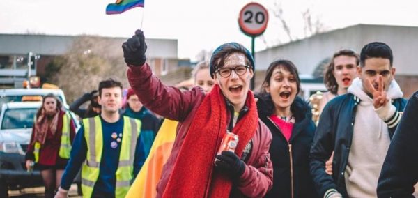 Image may contain: Photo, Photography, Coat, People, Parade, Flag, Crowd, Symbol, Face, Costume, Apparel, Clothing, Human, Person