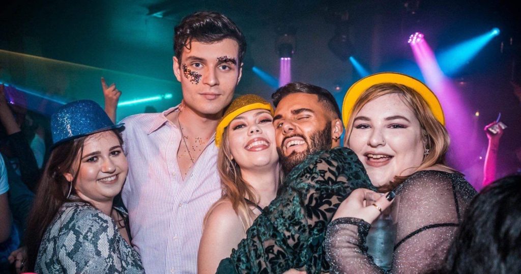 Image may contain: Night Life, Apparel, Clothing, Hat, Disco, Night Club, Party, Club, Person, Human