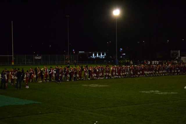 The teams shake hands