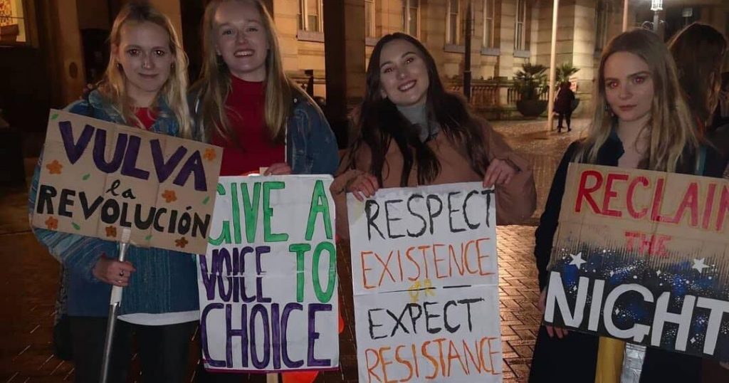 Image may contain: Crowd, Banner, Person, Human, Word, Text