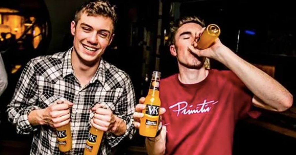 Image may contain: Drink, Beverage, Alcohol, Bottle, Tartan, Skirt, Plaid, Kilt, Clothing, Person, People, Human